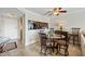 Cozy dining area with modern ceiling fan, glass table, and breakfast bar to kitchen at 610 Island Way # 302, Clearwater Beach, FL 33767