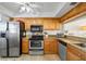 Well-equipped kitchen with stainless steel appliances and wood cabinetry at 610 Island Way # 302, Clearwater Beach, FL 33767