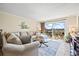 Bright living room featuring a sofa, stylish decor, and sliding glass doors leading to the balcony at 610 Island Way # 302, Clearwater Beach, FL 33767