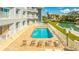 Enjoy the community's sparkling pool surrounded by lounge chairs and landscaped grounds at 610 Island Way # 302, Clearwater Beach, FL 33767