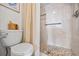 Tiled shower with pebble floor detail, handheld shower head, and built-in shelving at 610 Island Way # 302, Clearwater Beach, FL 33767