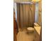 Bathroom with tiled floor, toilet and shower/tub with shower curtain at 7006 41St E Ave, Bradenton, FL 34208