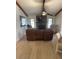 Inviting living room with stone fireplace, ceiling fan and comfortable furniture at 7006 41St E Ave, Bradenton, FL 34208