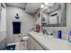 A clean bathroom featuring a white vanity, toilet, and decorative nautical theme at 7101 Channelside N Ln, Pinellas Park, FL 33781