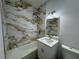 Modern bathroom with marble-style tiled walls and a sleek vanity at 7608 Lakeside Blvd, Tampa, FL 33614