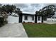 Charming home boasts fresh landscaping, a fenced yard, and a freshly painted exterior at 7608 Lakeside Blvd, Tampa, FL 33614