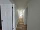 Clean hallway with new flooring connects various rooms in the home at 7608 Lakeside Blvd, Tampa, FL 33614