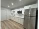 Modern kitchen with white cabinetry, stainless steel appliances, and sleek countertops at 7608 Lakeside Blvd, Tampa, FL 33614