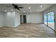 Open living room with wood floors and sliding glass doors to the pool area at 7608 Lakeside Blvd, Tampa, FL 33614