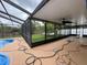 Large screened in patio overlooking backyard and pool offers shade for relaxing and entertaining at 7608 Lakeside Blvd, Tampa, FL 33614