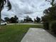 Quiet residential street with well-maintained lawns, mature trees, and sidewalks at 7608 Lakeside Blvd, Tampa, FL 33614