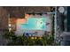 Aerial shot of backyard pool and patio area with lounge chairs, tropical plants, and privacy fence at 7912 3Rd S Ave, St Petersburg, FL 33707