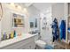 Bright bathroom featuring a glass shower, white vanity and blue rug at 7912 3Rd S Ave, St Petersburg, FL 33707