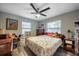 Cozy bedroom with hardwood floors, natural light, and charming decor with a ceiling fan at 7912 3Rd S Ave, St Petersburg, FL 33707