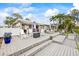 Spacious outdoor deck with rocking chairs, an outdoor kitchen, and a lush yard at 7912 3Rd S Ave, St Petersburg, FL 33707