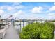 Scenic dock view with an American flag, providing waterfront access and a charming coastal atmosphere at 7912 3Rd S Ave, St Petersburg, FL 33707