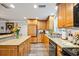 Charming kitchen featuring wooden cabinets, granite countertops, and modern stainless steel appliances at 7912 3Rd S Ave, St Petersburg, FL 33707