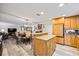 Open kitchen with wood cabinets, granite counters, island, dining area and stainless steel appliances at 7912 3Rd S Ave, St Petersburg, FL 33707