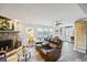 Spacious living room features a stone fireplace, wood floors, and access to outdoor patio at 7912 3Rd S Ave, St Petersburg, FL 33707