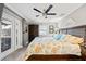 Comfortable bedroom with ceiling fan, wood floors, coastal decor, and closet at 7912 3Rd S Ave, St Petersburg, FL 33707