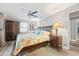 Comfortable bedroom with ceiling fan, wood floors, coastal decor, and ensuite bathroom at 7912 3Rd S Ave, St Petersburg, FL 33707