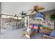 Covered patio boasts a stone wall, ceiling fans, a bar, and seating at 7912 3Rd S Ave, St Petersburg, FL 33707