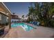 Backyard with a well-maintained pool and lush tropical landscaping at 7912 3Rd S Ave, St Petersburg, FL 33707
