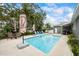 Backyard pool with lounge chairs and tables, and lush tropical landscaping at 7912 3Rd S Ave, St Petersburg, FL 33707