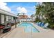 Backyard pool with chairs and lounge seating, surrounded by lush landscaping at 7912 3Rd S Ave, St Petersburg, FL 33707
