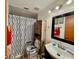 Compact bathroom with a vanity, mirror, and shower featuring patterned curtain, providing a functional space at 804 Valley Hill Ct, Brandon, FL 33510