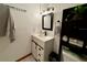 Well-lit bathroom featuring a modern vanity with storage and a decorative mirror and towel rack at 804 Valley Hill Ct, Brandon, FL 33510