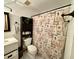 Functional bathroom featuring a toilet, cabinet storage, vanity, sink, and a shower with a themed curtain at 804 Valley Hill Ct, Brandon, FL 33510
