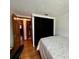 Cozy bedroom featuring hardwood flooring, with black privacy curtains at 804 Valley Hill Ct, Brandon, FL 33510