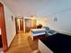 Spacious bedroom with hardwood floors, two beds, a closet, and a cozy seating area at 804 Valley Hill Ct, Brandon, FL 33510