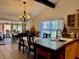Bright eat-in kitchen featuring honey-colored cabinets, tile floors, and a chandelier over a dining table at 804 Valley Hill Ct, Brandon, FL 33510