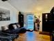Comfortable living room with hardwood floors, a dark sectional couch, and a large window offering plenty of natural light at 804 Valley Hill Ct, Brandon, FL 33510