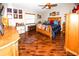 Spacious bedroom with wood floors, ceiling fan, and ample natural light from a window at 8703 Elm Leaf Ct, Port Richey, FL 34668