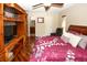 Comfortable main bedroom featuring a ceiling fan, television and ensuite bathroom at 8703 Elm Leaf Ct, Port Richey, FL 34668