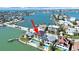Aerial view of waterfront property with a pool and luxurious landscaping near the ocean at 882 Bay Point Dr, Madeira Beach, FL 33708