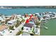 Stunning aerial view of waterfront home with private pool and dock access to the serene blue waters at 882 Bay Point Dr, Madeira Beach, FL 33708