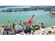 Aerial view of a waterfront property with a private dock and lush landscaping at 882 Bay Point Dr, Madeira Beach, FL 33708