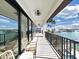 Relax on this covered balcony with water views and a metal railing at 882 Bay Point Dr, Madeira Beach, FL 33708