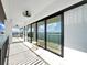 Covered balcony with water views, tile floors, and a dark metal railing at 882 Bay Point Dr, Madeira Beach, FL 33708