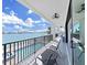 Relaxing balcony with waterfront views and comfortable seating perfect for enjoying the outdoors at 882 Bay Point Dr, Madeira Beach, FL 33708