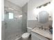 Bathroom with glass enclosed shower, marble vanity, and modern finishes at 882 Bay Point Dr, Madeira Beach, FL 33708