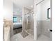 Stylish bathroom featuring a glass enclosed shower, separate toilet room, and bedroom views at 882 Bay Point Dr, Madeira Beach, FL 33708