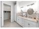 Bright bathroom featuring double sinks, ample counter space, and a connected walk-in closet at 882 Bay Point Dr, Madeira Beach, FL 33708
