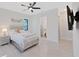 Bright bedroom with a ceiling fan and adjoining bathroom at 882 Bay Point Dr, Madeira Beach, FL 33708