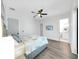 Bedroom with a ceiling fan, tv, and ensuite bathroom at 882 Bay Point Dr, Madeira Beach, FL 33708