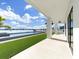 Gorgeous backyard with a pool, artificial grass, covered patio, and a beautiful waterfront view at 882 Bay Point Dr, Madeira Beach, FL 33708